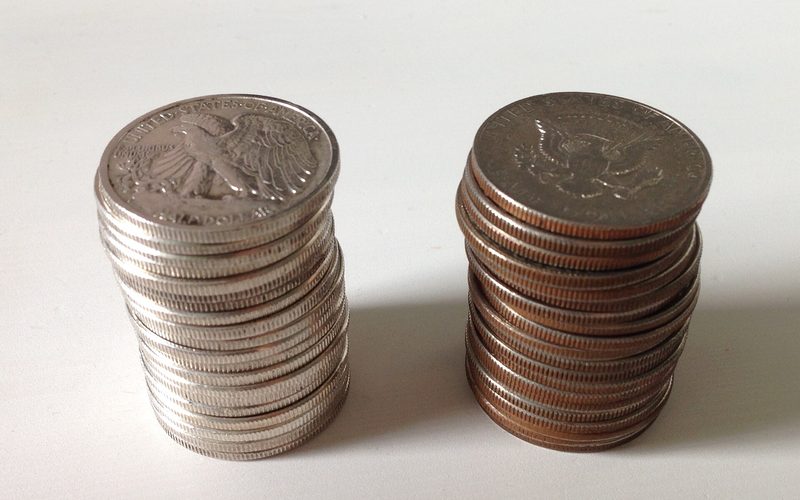 Two stacks of coins, one silver, one clad.