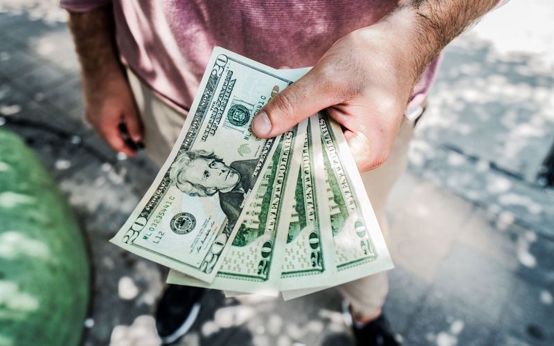 A stack of one hundred dollar bills.